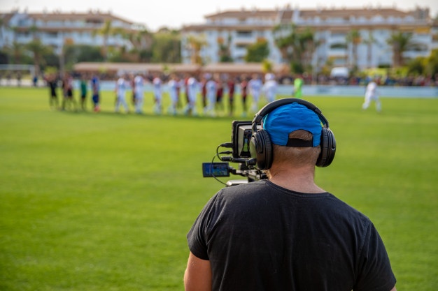 cameraman-with-camera-shooting-video-football-game_155027-495